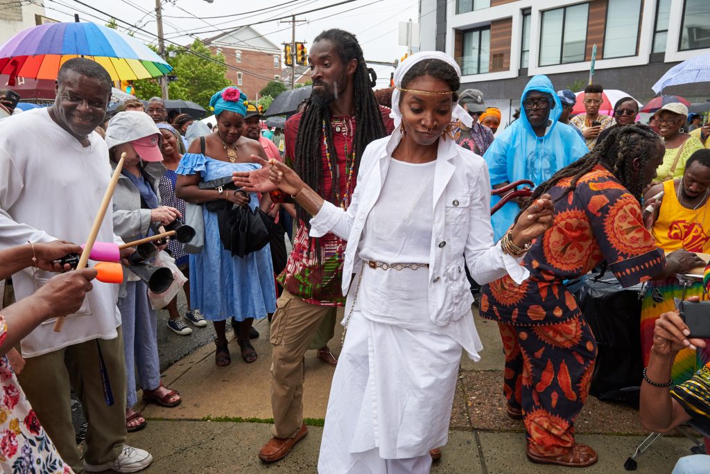 2018 06 10-n piserchio-street dancers-odunde festival People dancing in the street with people playing hand-held instruments near them