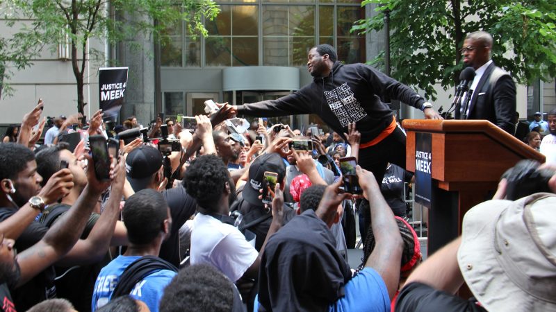 Meek Mill reaches out to supporters outside the Criminal Justice Center before his hearing to ask for a new trial on 10-year-old gun and drug charges. (Emma Lee/WHYY)