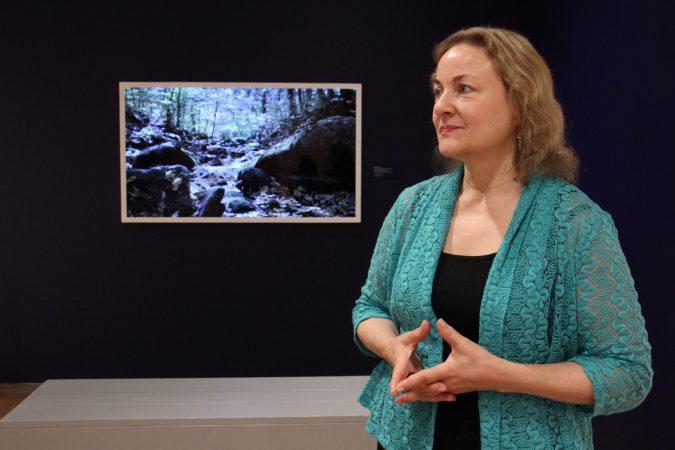 Curator Suzanne Ramljak stands before 