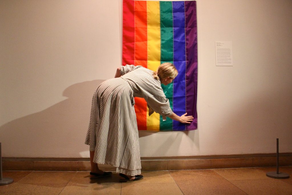 2018 06 25-e lee-michelle millar fisher-philadelphia art museum-rainbow flag anniversary Philadelphia Museum of Art Assistant Curator Michelle Millar Fisher hangs a rainbow flag marking the 40th anniversary of the unfurling of the original at the Gay Freedom Day Parade in San Francisco on June 25, 1978. The flag was designed by Gilbert Baker, who referred to himself as the