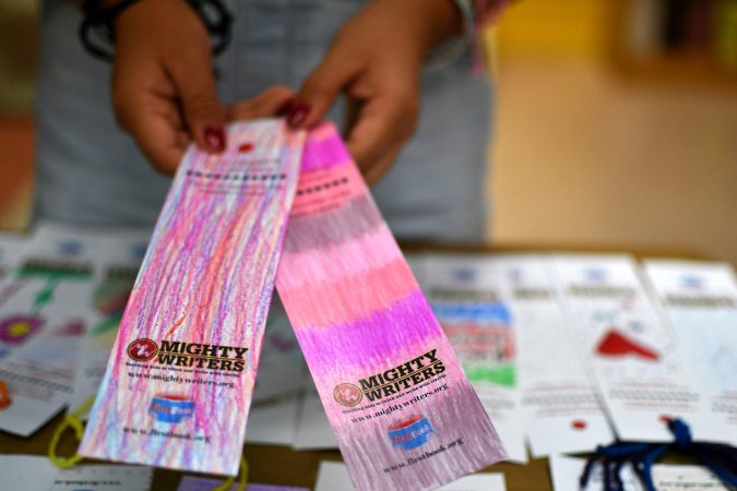 Yaretzy, 11, shows some of the bookmarks she made at Mighty Writers El Futuro in South Philadelphia.  (Bastiaan Slabbers for WHYY)