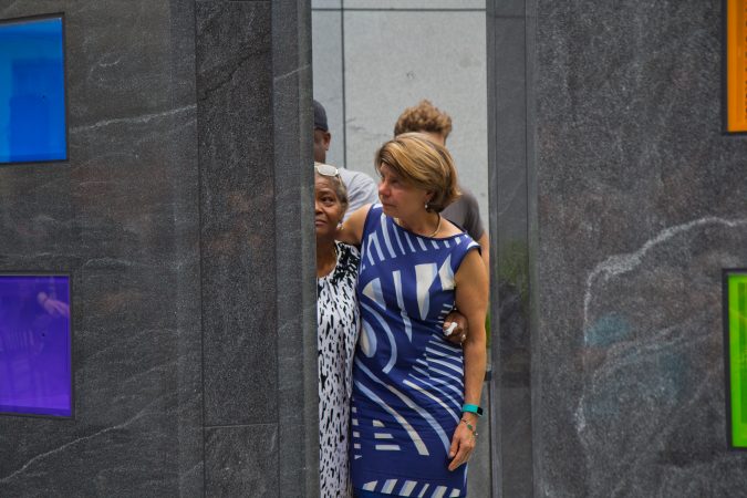 Maggie Adams Davis, (left) wife of Borbor Davis, and Nancy Winkler, (right) mother of Anne Bryan, remember their loved ones at the memorial. (Kimberly Paynter/WHYY)