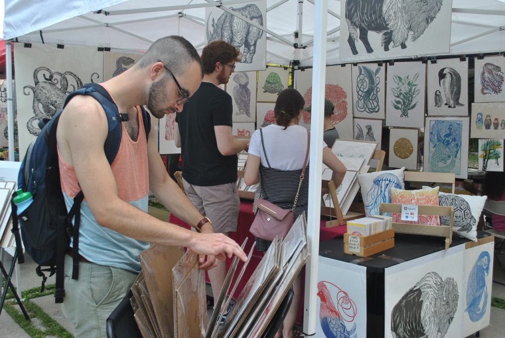 Visitors peruse the offerings at Art for the Cash Poor
