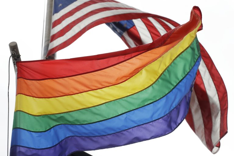 The Rainbow Flag flies beneath the American flag at the Stonewall National Monument, Wednesday, Oct. 11, 2017, in New York. The Rainbow Flag, an international symbol of LGBT liberation and pride, was flown for the first time at the monument. (Mark Lennihan/AP Photo)