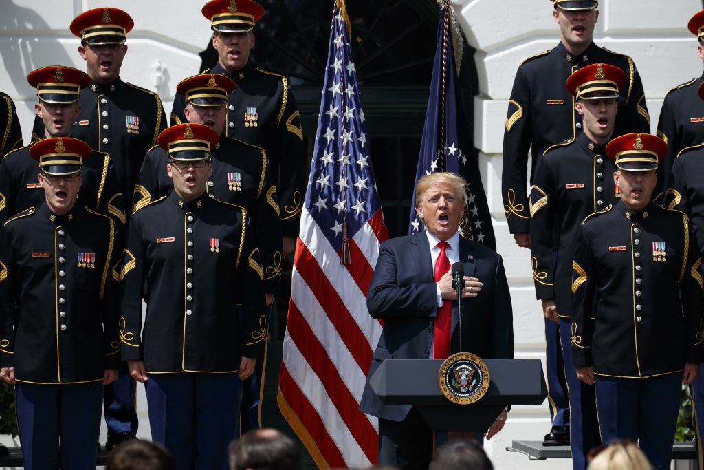 Donald Trump President Donald Trump sings the national anthem during a