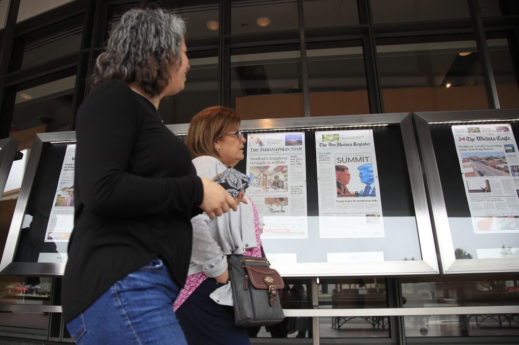 AP Poll Trust in Media Newseum visitors browse newspaper front pages displayed outside the museum in Washington, Monday, June 11, 2018.