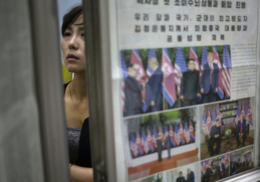 APTOPIX Trump Kim Summit Pyongyang Reacts A woman reads newspapers fronting the news on President Donald Trump's summit with North Korean leader Kim Jong Un at Puhung subway station in Pyongyang, North Korea, Wednesday, June 13, 2018. The series of photos on the front page of the ruling workers' party newspaper showed something North Koreans never would have imagined just months ago — their leader Kim Jong Un warmly shaking hands with President Donald Trump. (Dita Alangkara/AP Photo)