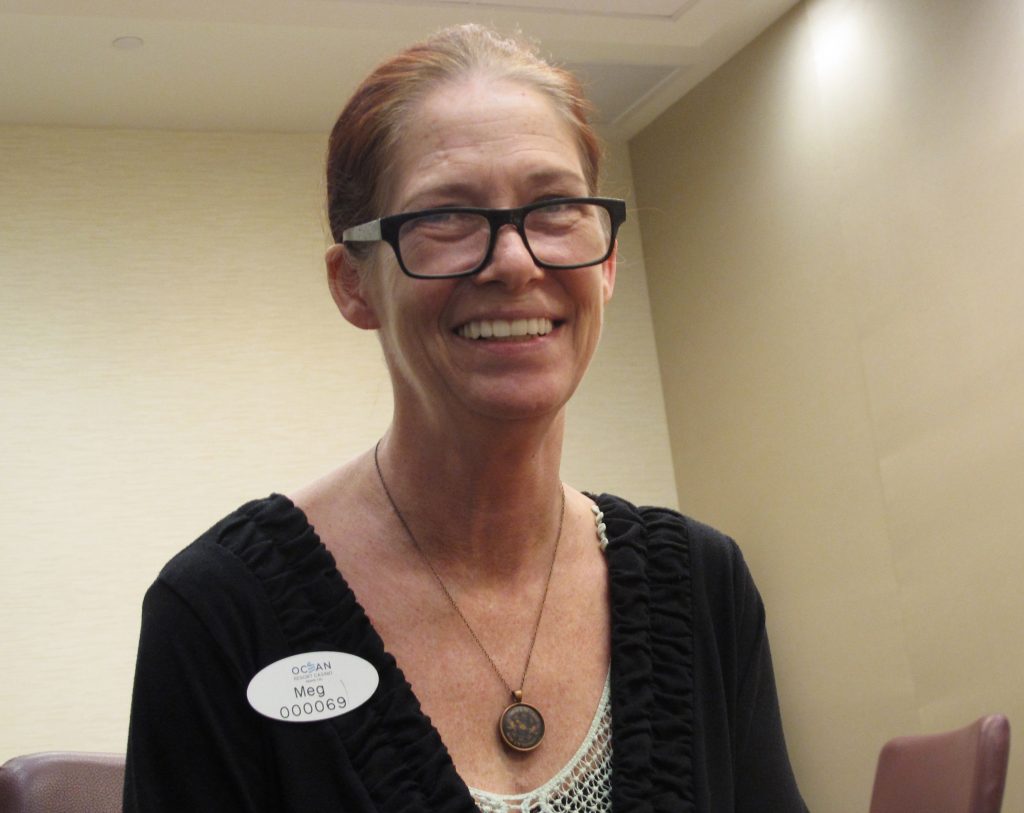 In this June 11, 2018 photo, Meg Timson, a human resources manager at the soon-to-open Ocean Resort Casino poses for a photo in Atlantic City, N.J. She held the same job at the casino when it was known as Revel. She is among many workers at Revel and the Trump Taj Mahal who lost their jobs when the casinos shut down who are getting them back now that the casinos are reopening under new owners. (AP Photo/Wayne Parry)