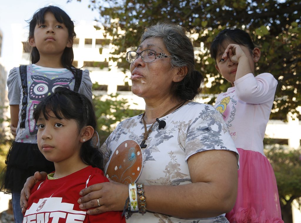 Immigration Family Separation Lucia Ajas, middle, talks about her and her children, Regina Vargas, 7, left, Akemi Vargas, 8, second from left, and Trinidad Vargas, 5, right, being separated from their father during an immigration family separation protest in front of the Sandra Day O'Connor U.S. District Court building, Monday, June 18, 2018, in Phoenix.