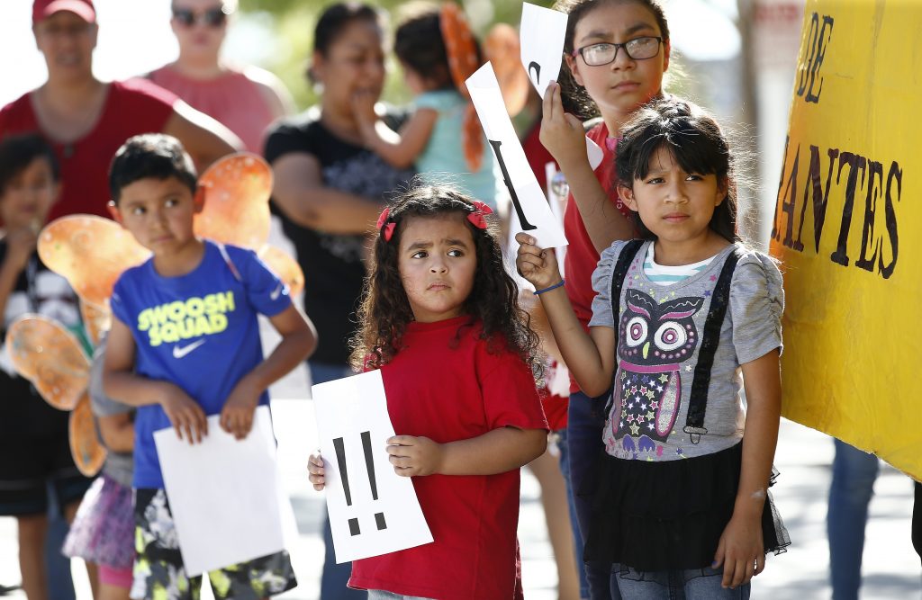 Immigration Family Separation Children listen to speakers during an immigration family separation protest in front of the Sandra Day O'Connor U.S. District Court building, Monday, June 18, 2018, in Phoenix. An unapologetic President Donald Trump defended his administration's border-protection policies Monday in the face of rising national outrage over the forced separation of migrant children from their parents. (AP Photo/Ross D. Franklin)