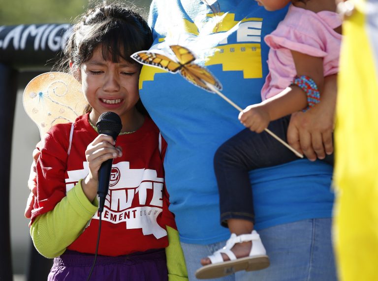 Akemi Vargas, 8, cries as she talks about being separated from her father