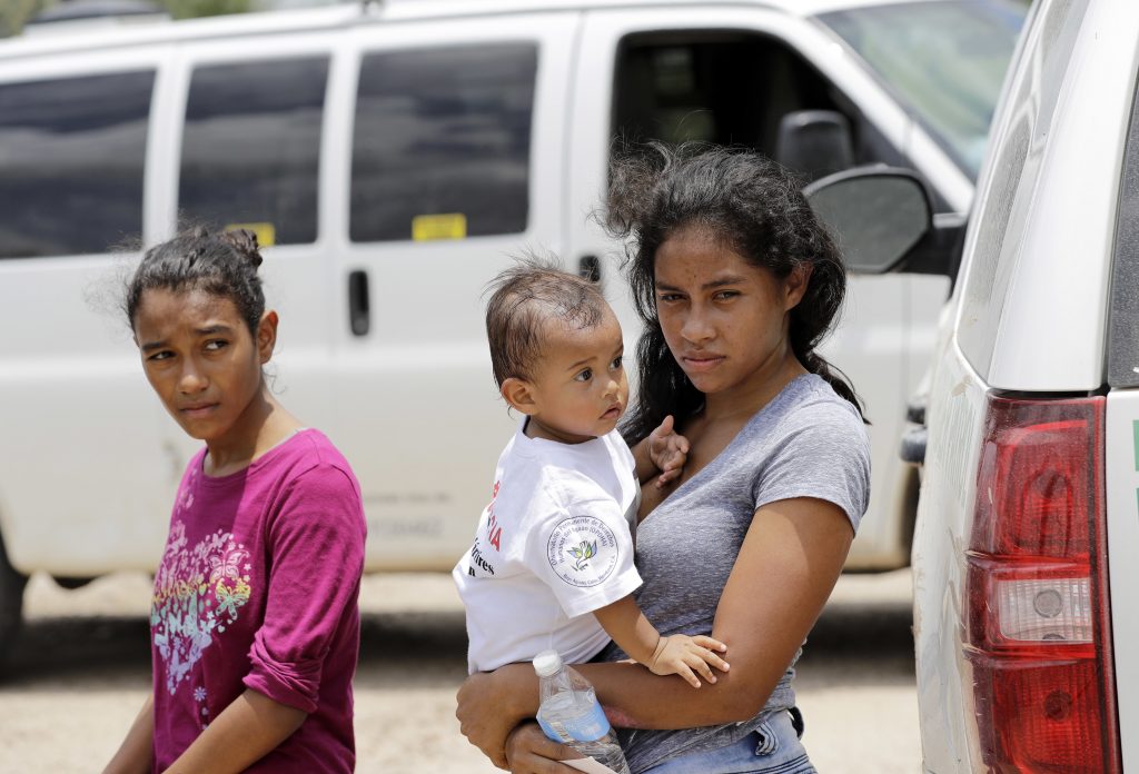 Immigrant mother A mother migrating from Honduras holds her 1-year-old child as surrendering to U.S. Border Patrol agents after illegally crossing the border Monday, June 25, 2018, near McAllen, Texas. (AP Photo/David J. Phillip)