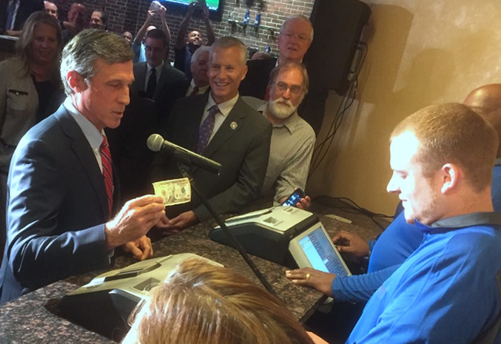 DELsportsbettingx1200 Gov. John Carney, D-Delaware, places a $10 bet on the Phillies. (Zoe Read/WHYY)