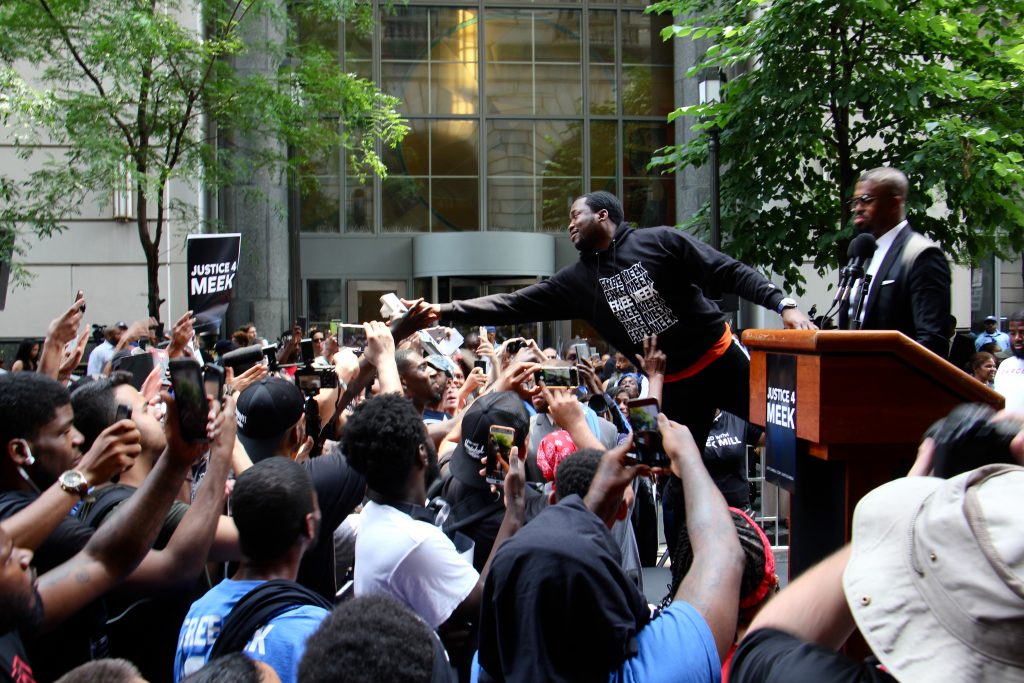 Image uploaded from iOS (42) Meek Mill reaches out to supporters outside the Criminal Justice Center before his hearing to ask for a new trial on 10-year-old gun and drug charges.