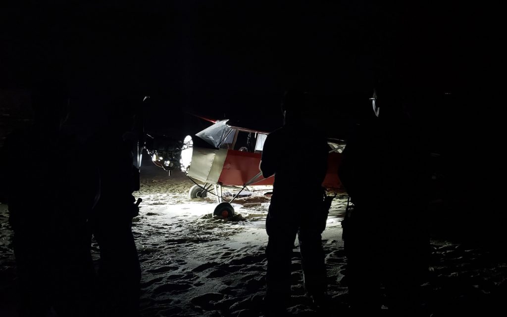 Pilot_Missing_34582-1242×777 In this June 24, 2018 photo, Coast Guard personnel stand in front of a plane on a secured beach on the southeast side of the U.S. Coast Guard Training Center Cape May after it landed illegally and there was no sign of the pilot. The Coast Guard says officers became aware of the incident when the plane was spotted on closed-circuit cameras. (Petty Officer 2nd Class Richard/U.S. Coast Guard via AP)