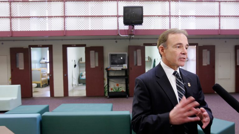 Garry Mead, assistant director of detention and removal for Immigration and Customs Enforcement, answers a reporter's question in 2007 in front of cells that housed immigrant families at the T. Don Hutto Residential Center in Taylor, Texas. After a suit by the ACLU, the center ended family detention, and ICE mostly avoided it until 2014. (LM Otero/AP)