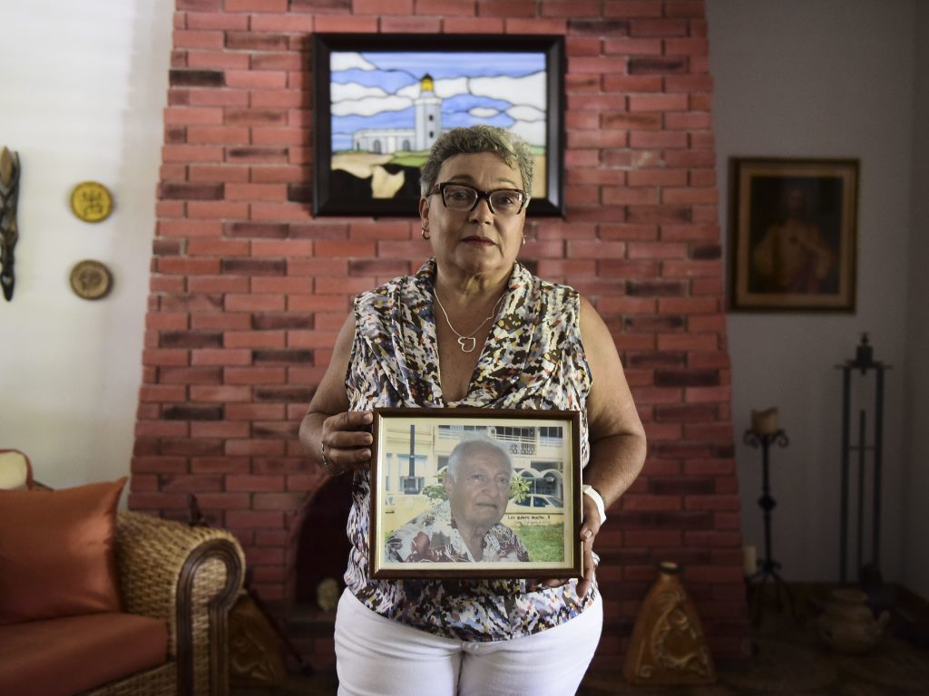 Puerto Rican Nerybelle Perez poses with a portrait of her father, World War II veteran Efrain Perez, who died after his ambulance was turned away from the island’s largest public hospital when it had no electricity or water following Hurricane Maria. Puerto Rican Nerybelle Perez poses with a portrait of her father, World War II veteran Efrain Perez, who died after his ambulance was turned away from the island's largest public hospital when it had no electricity or water following Hurricane Maria. (Carlos Giusti/AP)