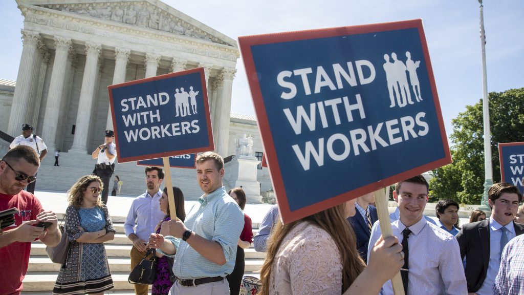 People gather at the Supreme Court awaiting a decision in an Illinois union dues case, Janus v. AFSCME, on Monday. People gather at the Supreme Court awaiting a decision in an Illinois union dues case, Janus v. AFSCME, on Monday. (J. Scott Applewhite/AP)