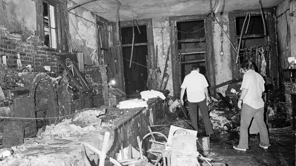 A view inside the Up Stairs bar following a fire that left 32 dead and several more injured, seen on June 25, 1973. Most of the victims were found near the windows in the background. A view inside the Up Stairs bar following a fire that left 32 dead and several more injured, seen on June 25, 1973. Most of the victims were found near the windows in the background. (Jack Thornell/AP)