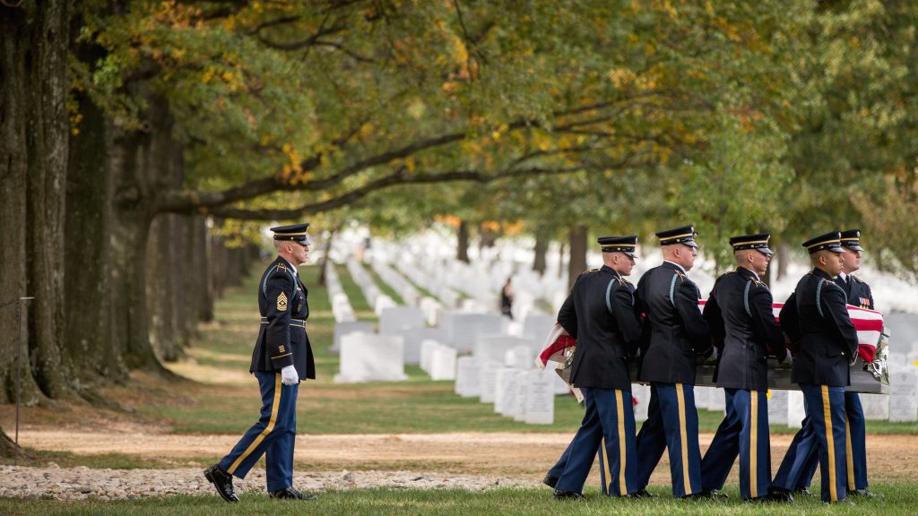 A casket team carries the remains of U.S. Army Cpl. Robert E. Meyers, a Korean War soldier, at Arlington National Cemetery in 2015. Meyers' remains were identified decades after his unit was involved in combat operations near Sonchu, North Korea. (Andrew Harnik/AP)