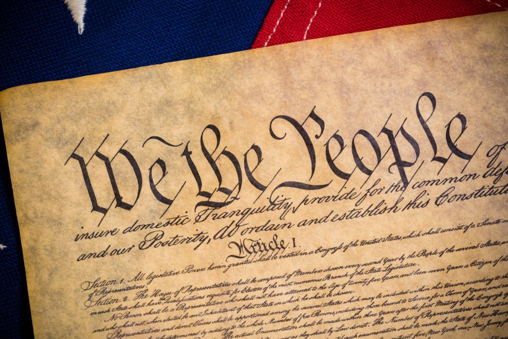 The constitution of the United States of American with a vintage The constitution of the United States of American with a vintage flag