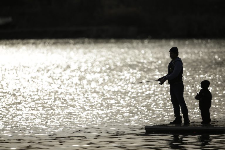 A father and son fish at Meadow Lake in Franklin Delano Roosevelt Park, Monday, March 16, 2015, in Philadelphia. (AP Photo/Matt Slocum)