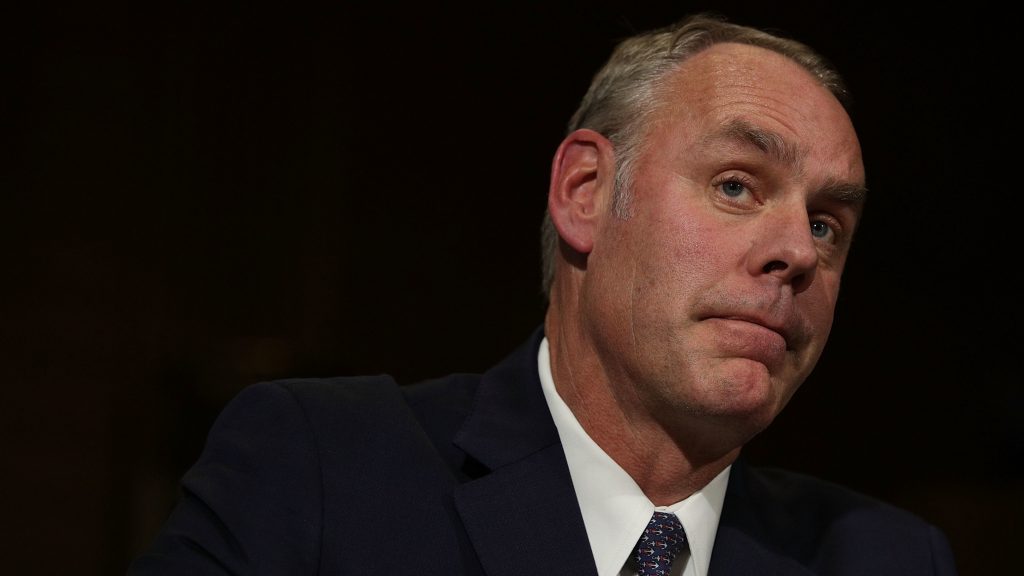 Interior Secretary Ryan Zinke at his confirmation hearing last year. Congressional Democrats and a public watchdog group are calling for an ethics investigation into Zinke over a land deal between his family foundation and oil and gas company Halliburton. Interior Secretary Ryan Zinke at his confirmation hearing last year. (Alex Wong/Getty Images)