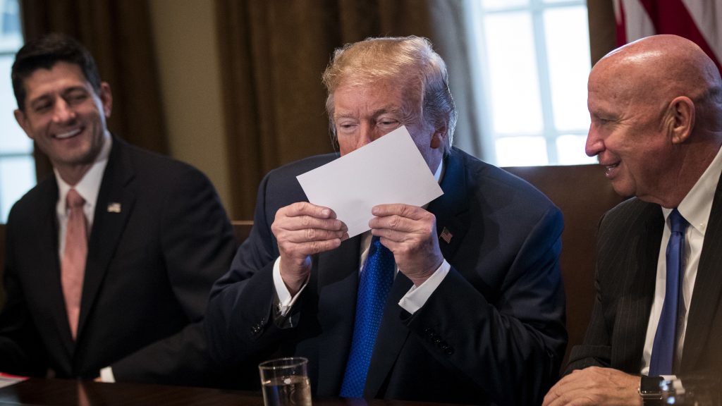 President Trump kisses a mock-up of a 1040 “postcard” during a meeting with GOP congressional leaders. President Trump kisses a mock-up of a 1040