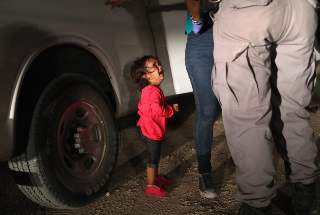 A 2-year-old Honduran girl cries as an official searches her mother in McAllen, Texas, near the U.S.-Mexico border, earlier this month. For many, the image has become indelibly associated with a Trump administration policy that for weeks separated migrant children from their parents — but the girl’s father says she was not separated from her mother. A 2-year-old Honduran girl cries as an official searches her mother in McAllen, Texas, near the U.S.-Mexico border, earlier this month. For many, the image has become indelibly associated with a Trump administration policy that for weeks separated migrant children from their parents — but the girl's father says she was not separated from her mother. (John Moore/Getty Images)