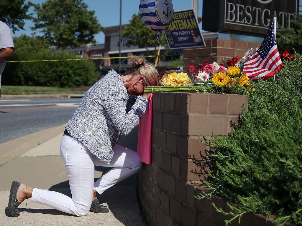 Lynne Griffin pays her respects at a makeshift memorial outside the Capital Gazette offices, one day after a gunman killed five people in its newsroom. Griffin was a journalism student under John McNamara — one of the people killed Thursday. Lynne Griffin pays her respects at a makeshift memorial outside the Capital Gazette offices, one day after a gunman killed five people in its newsroom. Griffin was a journalism student under John McNamara — one of the people killed Thursday. (Mark Wilson/Getty Images)