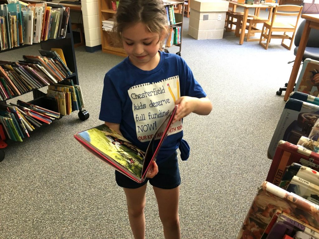 image001 A Chesterfield student peruses a graphic novel in the school library, which officials say doesn't have enough money for books. (Karen Rouse for WHYY News)