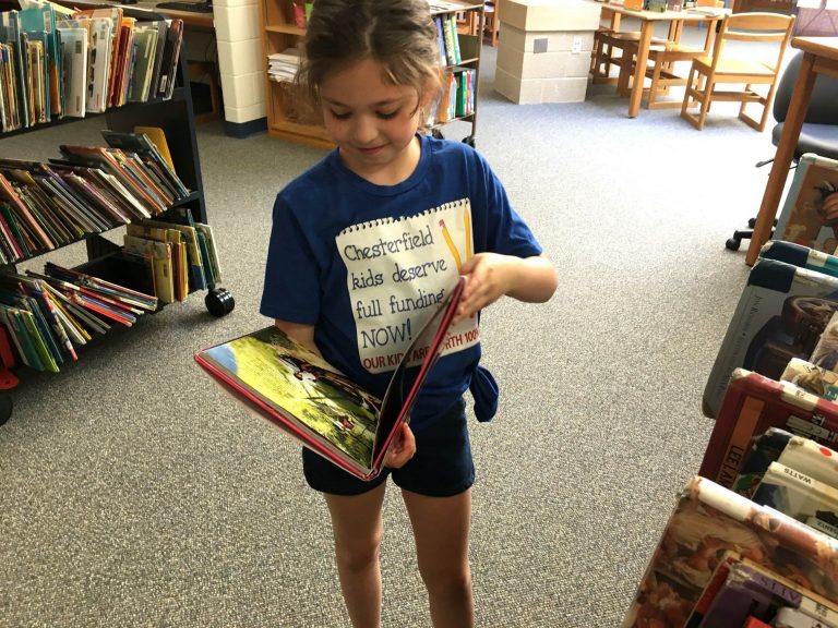 A Chesterfield student peruses a graphic novel in the school library, which officials say doesn't have enough money for books. (Karen Rouse for WHYY News)
