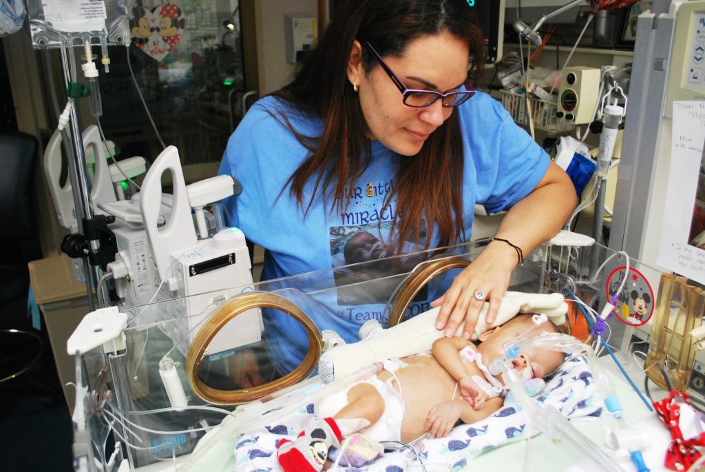 jacob-roxaniy Roxannie Vazquez watches over her son Jacob Ramiro at the neo-natal intensive care unit of a hospital in Macon, Georgia. He suffers from chronic lung disease. His mom says mold grew in his ventilator in Puerto Rico after Hurricane Maria damaged the pediatric hospital in San Juan. (Emily Cureton)