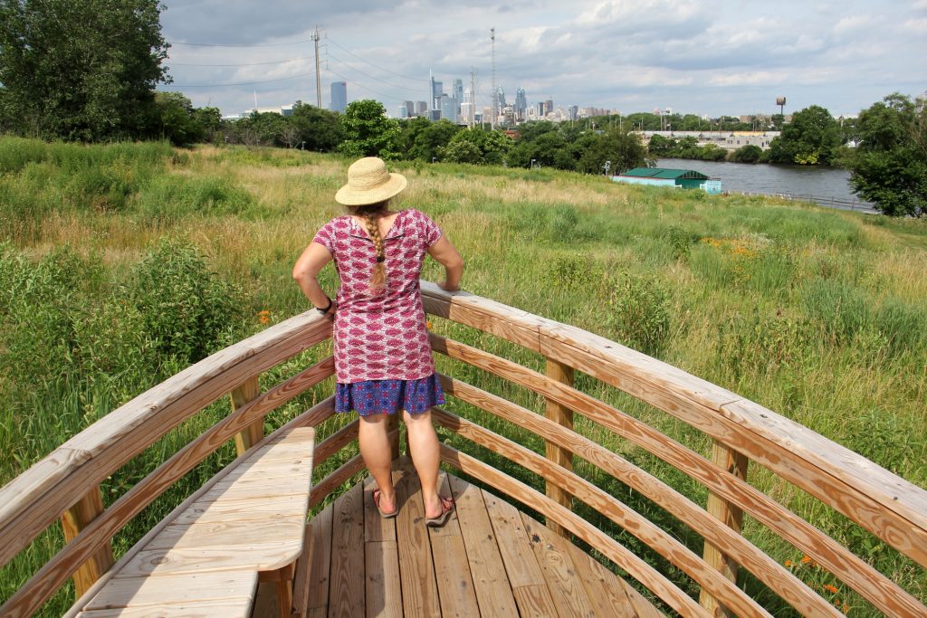 lead2018 06 26-e lee-stacy levy-philadelphia schuylkill river bartrams gardens-tide field and river rooms art installation Environmental artist Stacy Levy looks toward the Schuylkill River from the prow of one of her boatlike