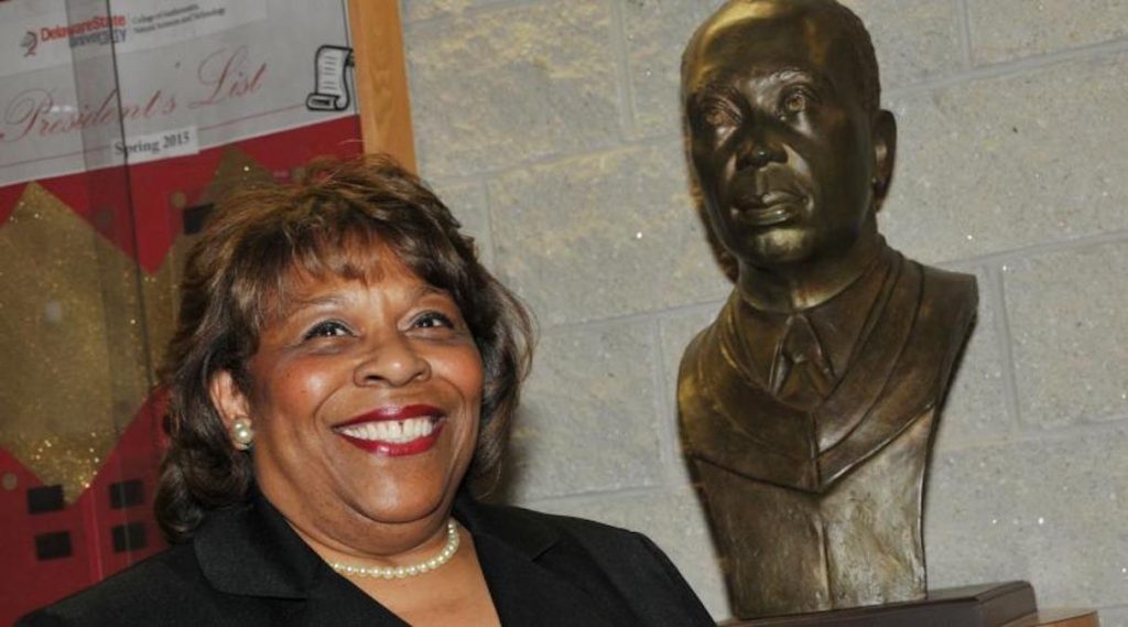 mishoe-and-dad Wilma Mishoe has been named the first permanent female president of Delaware State University. She has been interim president since January. The bust next to her is of her father Luna, who was the school's president from 1960 to 1987.