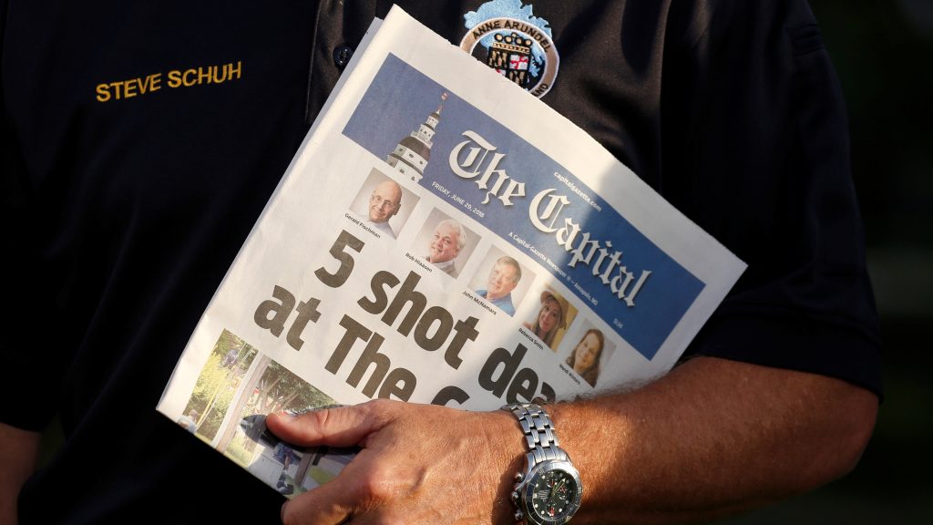 Staff of The Capital put out a newspaper on Friday, one day after a gunman killed five people in its offices at the Capital Gazette. Here, Steve Schuh, county executive of Anne Arundel County, Md., holds a copy of Friday’s paper. Staff of The Capital put out a newspaper on Friday, one day after a gunman killed five people in its offices at the Capital Gazette. Here, Steve Schuh, county executive of Anne Arundel County, Md., holds a copy of Friday's paper. (Joshua Roberts/Reuters)