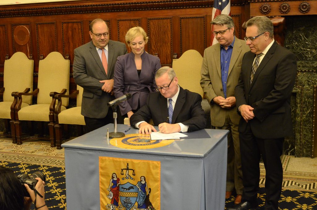 Philadelphia Mayor Jim Kenney signs the building new code into law Thursday. It will take effect in October. (Tom MacDonald, WHYY)