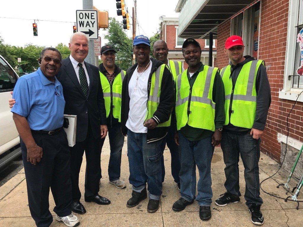 workers Wilmington Mayor Mike Purzycki stands with Apostle John T. Graham of Temple United Church and neighborhood residents employed to clean city streets and neighborhoods in West Center City. (City of Wilmington)