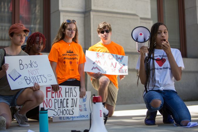 Simone Akridge, 15, takes a knee as she gives a powerful speech about how gun violence has affected her family and how necessary gun reform and voting is. Around 70 supporters gathered together for a march from the Philadelphia Art Museum to Independence Mall 105 days after the 