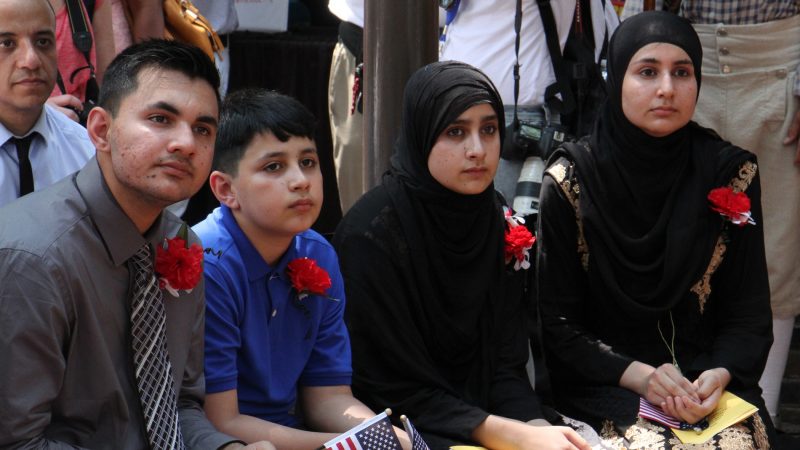 Four members of the Ali family from Pakistan, (from left) Asad, 14, Abid, 10, Gulalai, 11, and Gulghotai, 12, became  U.S. citizens at a Fourth of July naturalization ceremony at the Betsy Ross house. (Emma Lee/WHYY)
