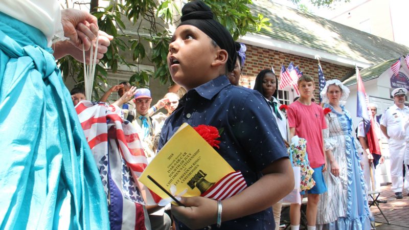 Gurvansh Singh, 7, rings a bell as part of the July 4 