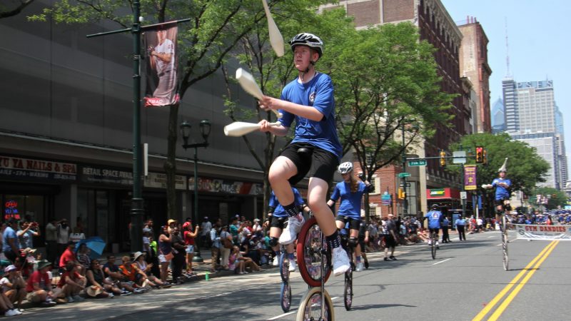 The Gym Dandies, trick cyclists from Scarborough Schools, Maine, perform during the Philadelphia Independence Day parade. (Emma Lee/WHYY)