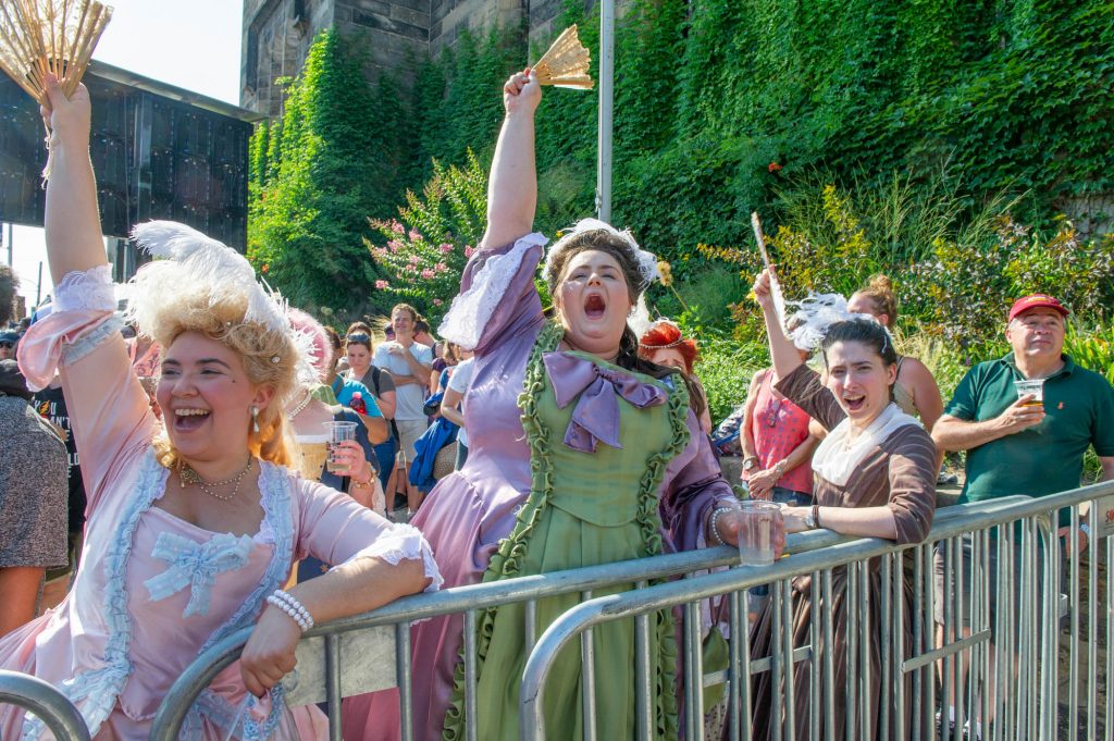 2018-07-14-j wilson -francesca negron ann patricia katherine patterson philadelphia fairmount bastille day-1 Revelers (from left) Francesca Negron, Ann Patricia, and Katherine Patterson, wear period costumes for the final Bastille Day performance on July 14, 2018. (Jonathan Wilson for WHYY)