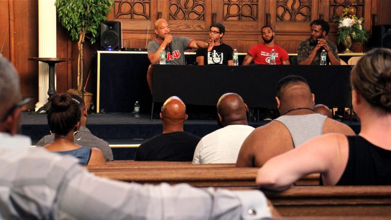 About 45 people attended a racial profiling workshop organized by Will Mega. Panelists included four Philadelphia educators (from left) Mega, Ismael Jimenez, Quamiir Trice, and Ben Slater, who detailed their recent experiences with racial profiling. (Emma Lee/WHYY)