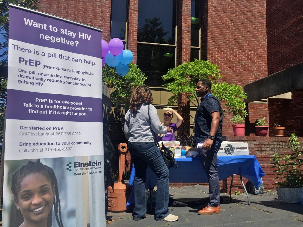 John Rose discusses PrEP with members of the community outside the Joseph E. Coleman Library in Germantown.