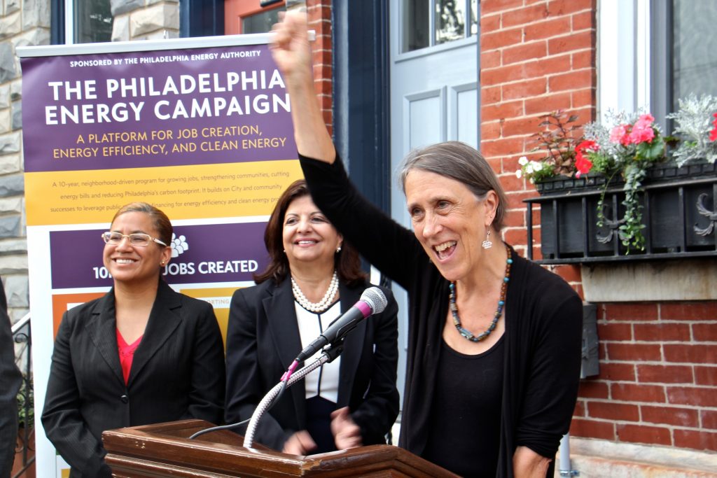 2018 07 26-e lee-joan kimball-philadelphia fairmount avenue-solar energy Homeowner Joan Kimball celebrates her home's conversion to solar power under a the Philadelphia Energy Campaign. Kimball's home, on Fairmount Avenue, became the 150th to go solar since the launch of the campaign to promote clean energy and create jobs