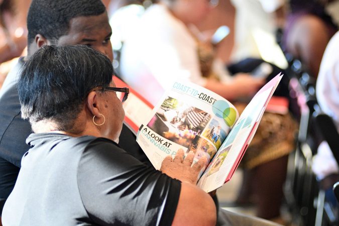 Audience members look over literature at a forum on the business of medicinal and recreational use of cannabis in the African-American community, at an event held on Thursday. (Bastiaan Slabbers for WHYY)