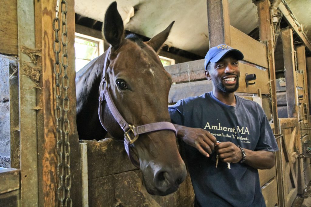 Daymar Rosser started at the Work to Ride program when he was 5, eventually playing polo for and graduating from Roger Williams University in Rhode Island. (Kimberly Paynter/WHYY)
