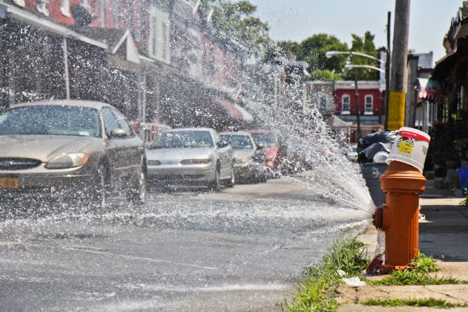 Fire hydrants are open around the city during an historic 2018 heat wave in Philadelphia. (Kimberly Paynter/WHYY)