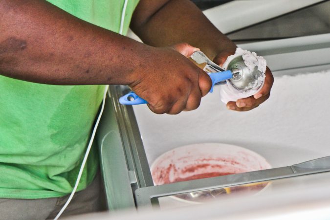 Dean Maitir serves cocoberry water ice at Siddiq’s in West Philadelphia. (Kimberly Paynter/WHYY)